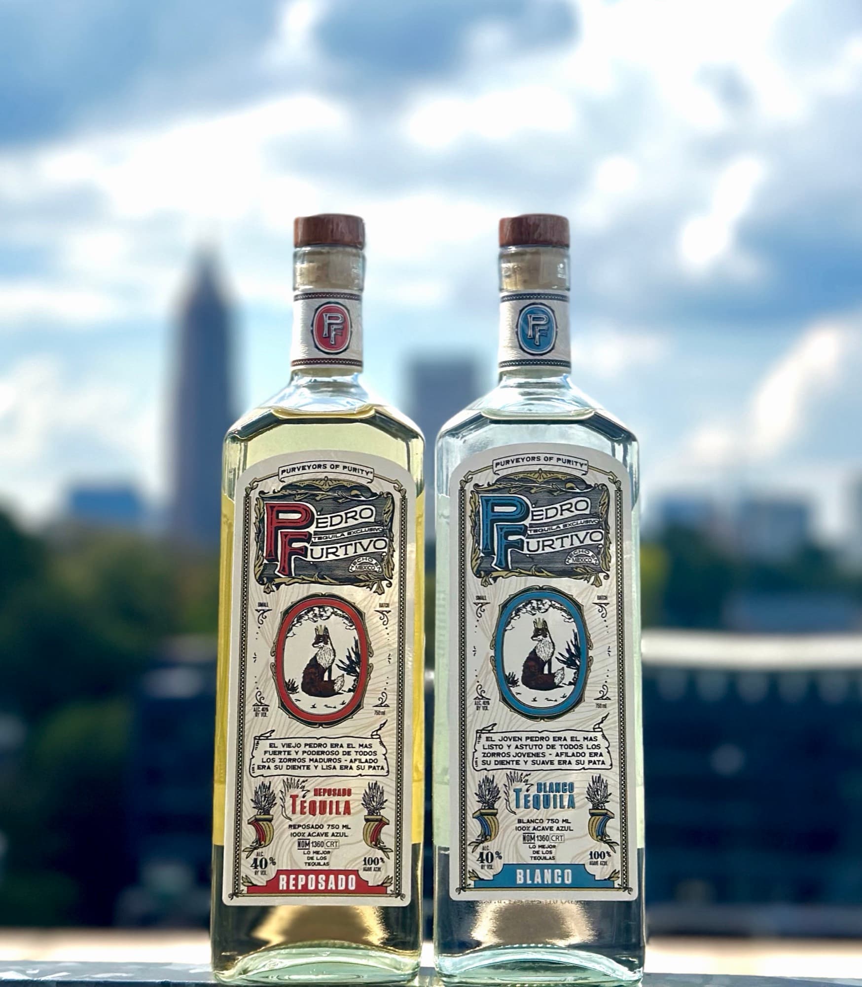 Bottles of Pedro Furtivo Reposado and Blanco against the Atlanta skyline