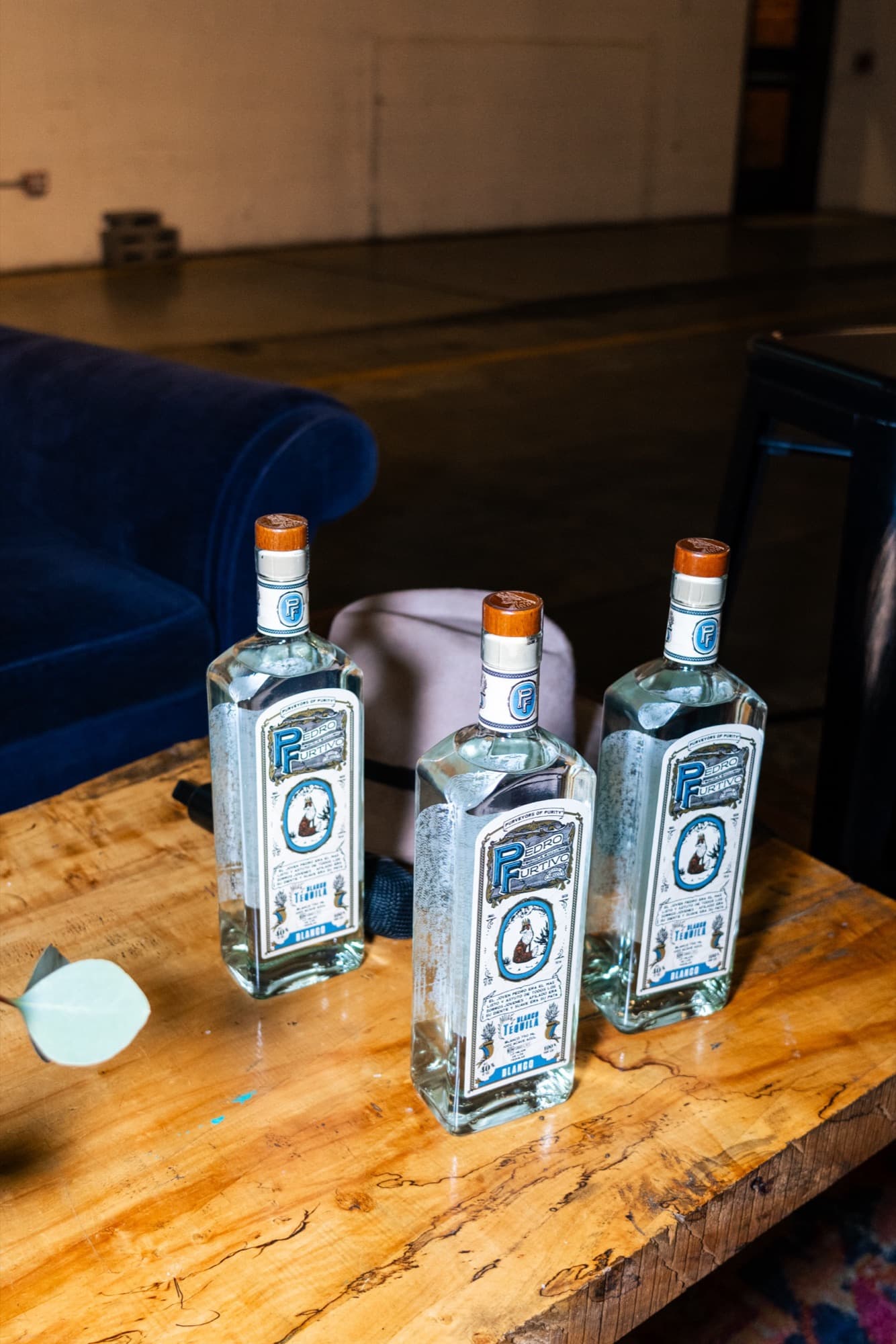 Three bottles of Pedro Furtivo Blanco on a wooden table