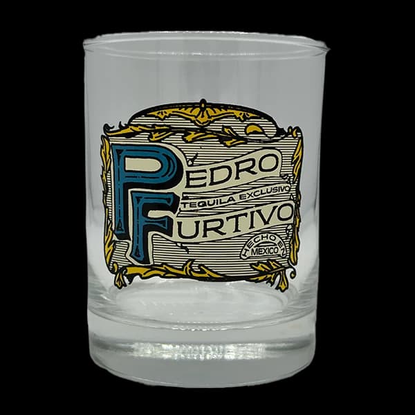 Clear rocks glass printed with the Pedro Furtivo Tequila Exclusivo label in blue and gold