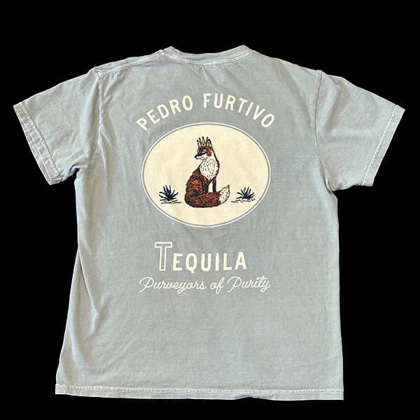Back of a sage-green T-shirt printed with Pedro Furtivo above a crowned fox in an oval, and Tequila, Purveyors of Purity below