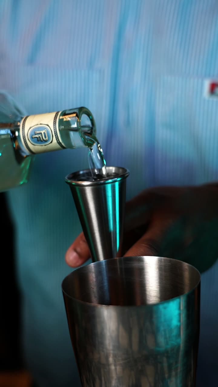 Pedro Furtivo Blanco poured into a jigger over a cocktail shaker