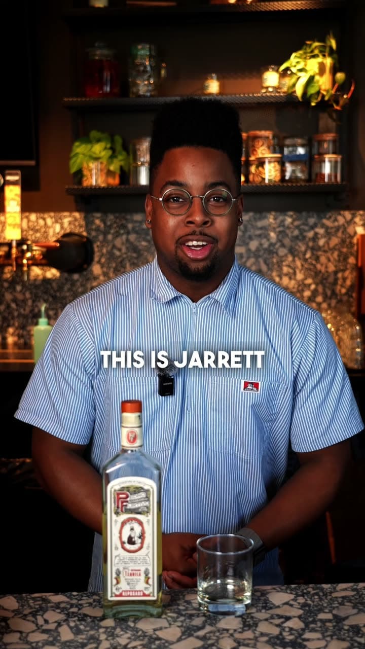 Jarrett behind a bar with a bottle of Pedro Furtivo Reposado and a glass